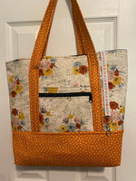Cream with orange, sky blue floral and orange polka dot base