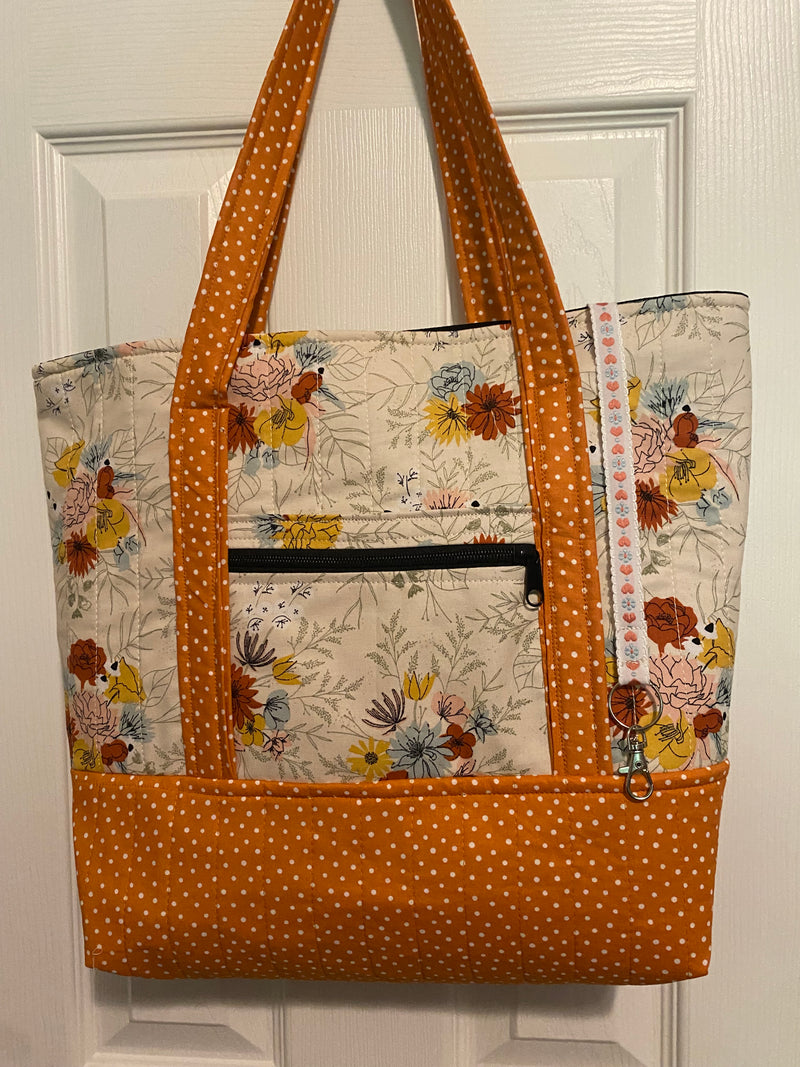Cream with orange, sky blue floral and orange polka dot base